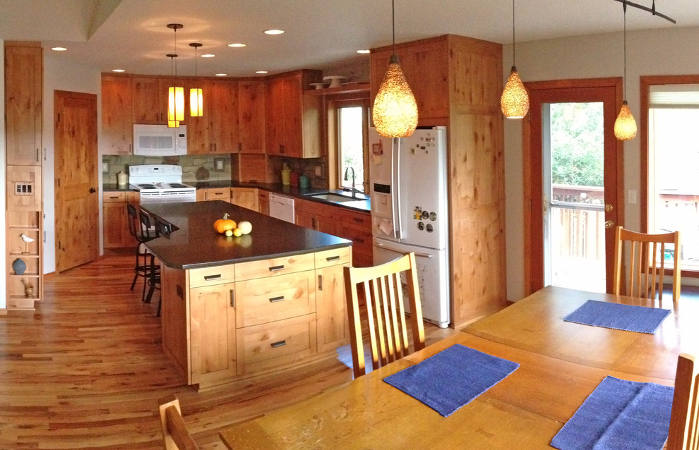 Open concept kitchen - large rustic u-shaped medium tone wood floor open concept kitchen idea with an undermount sink, shaker cabinets, medium tone wood cabinets, quartzite countertops, gray backsplash, stone tile backsplash and an island