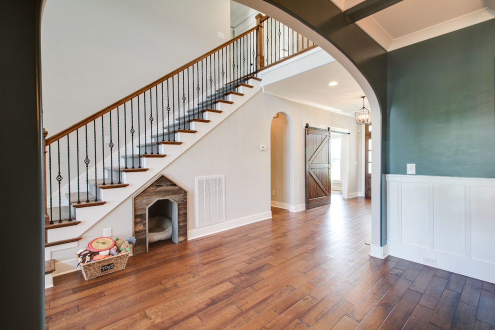Photo of a mid-sized arts and crafts wood l-shaped staircase in Nashville with painted wood risers and metal railing.