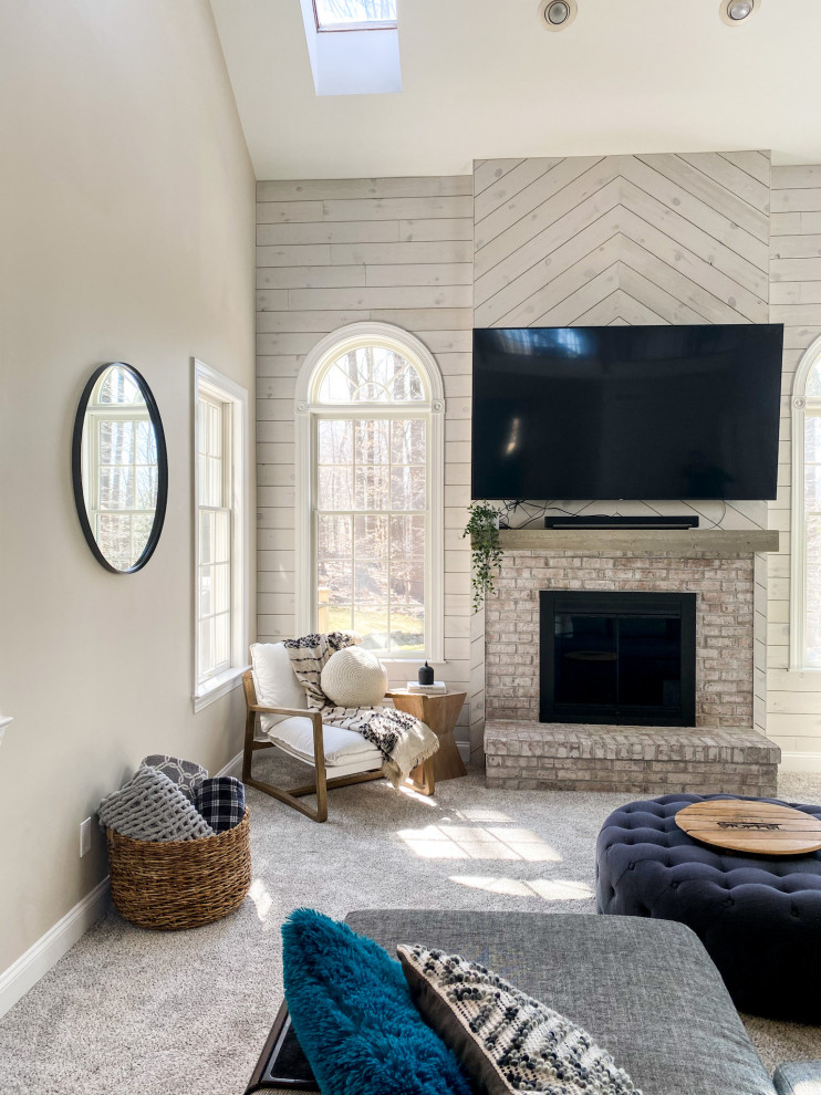 Large farmhouse open concept carpeted, beige floor, vaulted ceiling and shiplap wall living room photo in New York with beige walls, a standard fireplace, a brick fireplace and a wall-mounted tv
