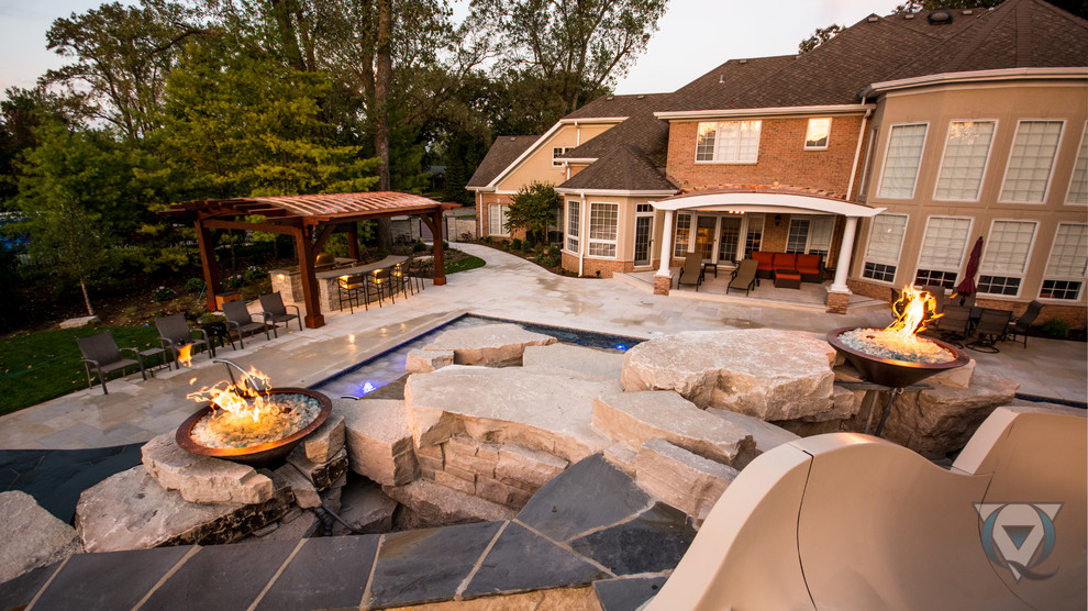Example of a large mountain style backyard stone and rectangular natural pool fountain design in Chicago
