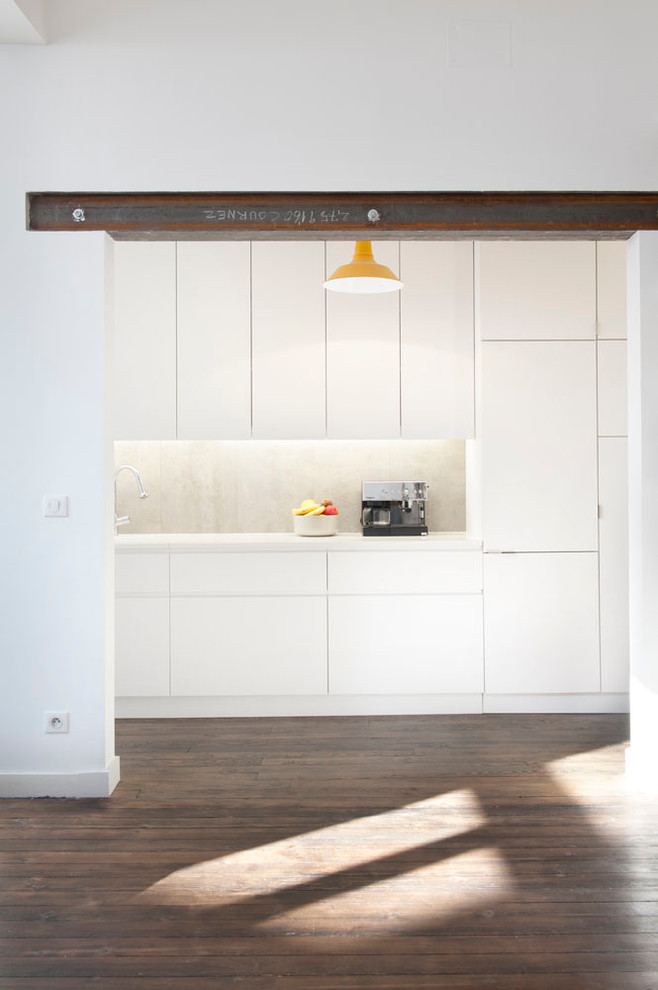This is an example of a mid-sized contemporary single-wall separate kitchen in Bordeaux with white cabinets and no island.