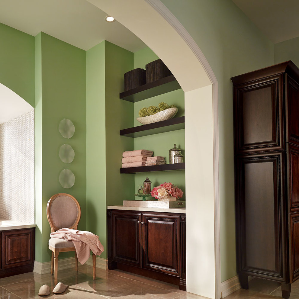 Design ideas for an expansive traditional master bathroom in Other with raised-panel cabinets, dark wood cabinets, an alcove tub, green walls, an undermount sink, beige floor and a hinged shower door.