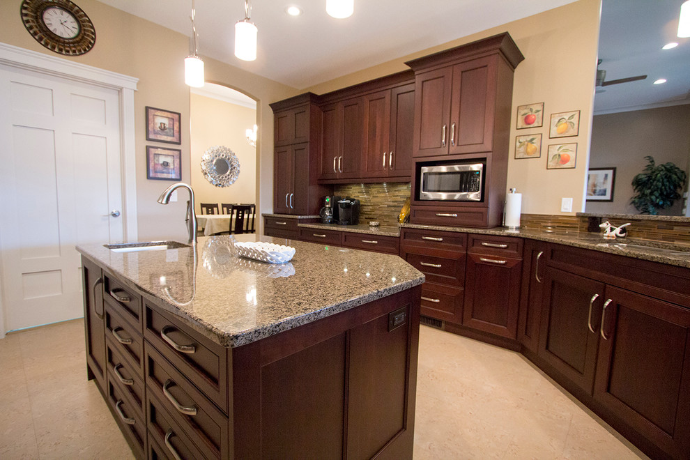Mid-sized transitional l-shaped enclosed kitchen photo with an undermount sink, recessed-panel cabinets, medium tone wood cabinets, granite countertops, stainless steel appliances and an island