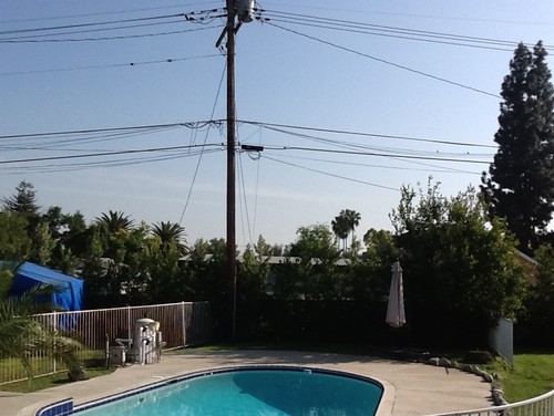 Need help - electric pole eyesore in my backyard
