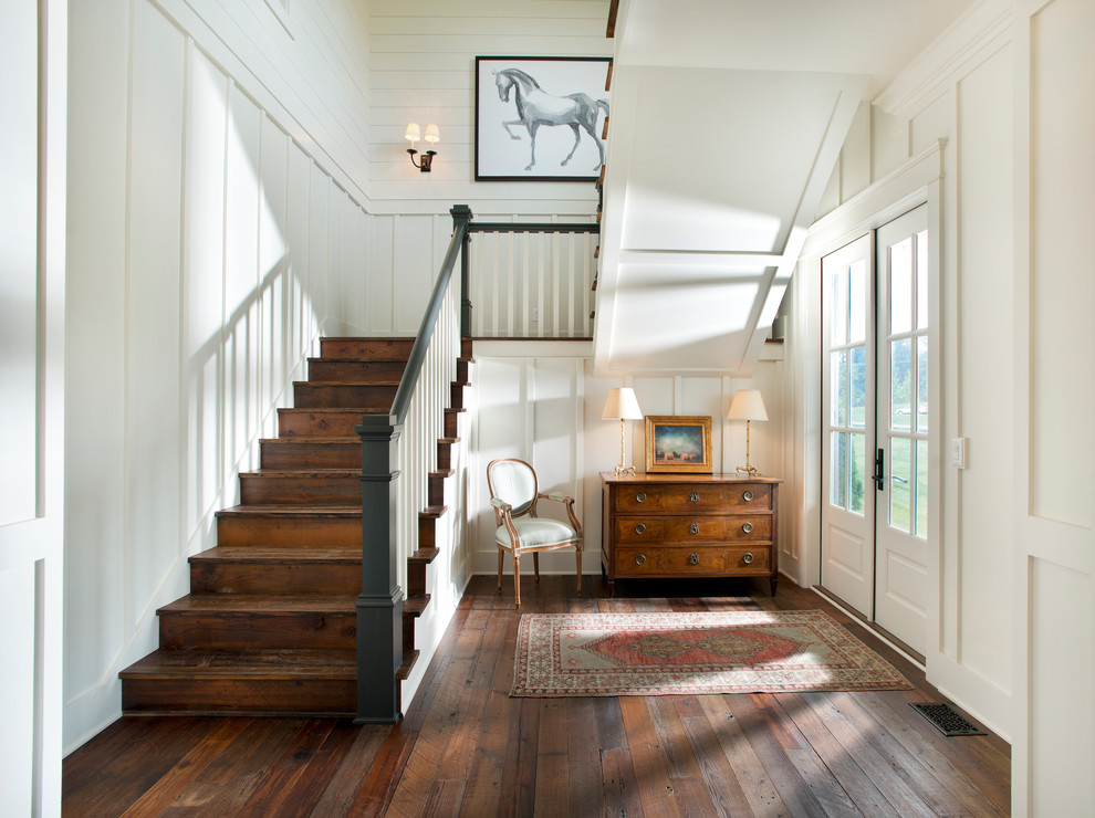 Design ideas for a country foyer in Nashville with white walls, dark hardwood floors, a double front door and a white front door.