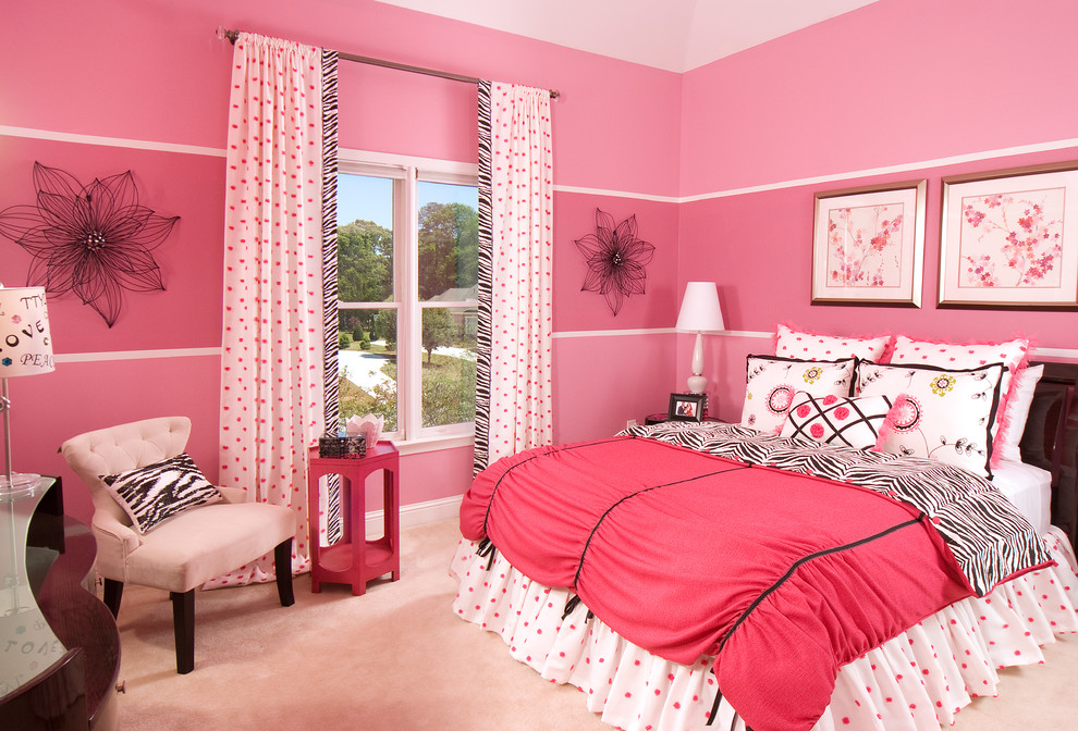 This is an example of a transitional kids' room for girls in Atlanta with pink walls and carpet.