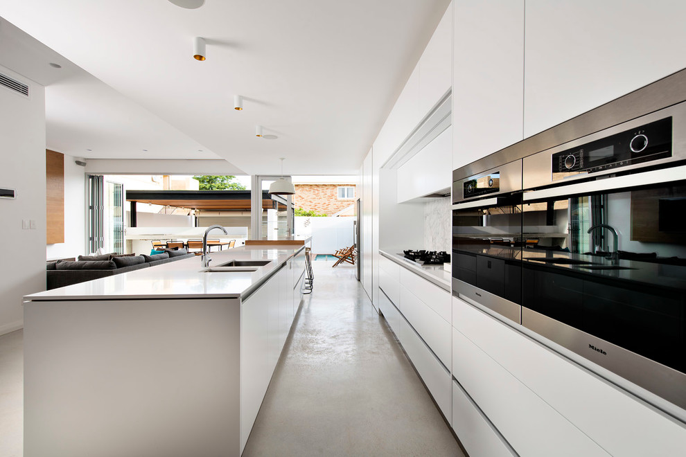 Design ideas for a contemporary kitchen in Perth with flat-panel cabinets, white cabinets and with island.