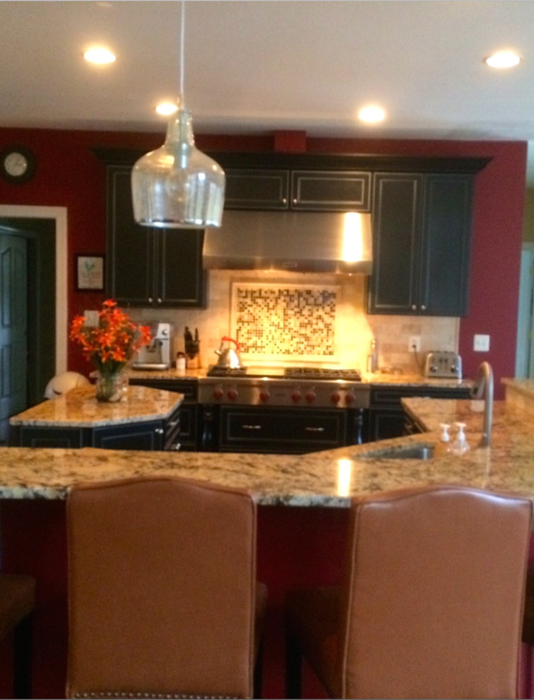 Mid-sized transitional kitchen photo in DC Metro with an undermount sink, recessed-panel cabinets, black cabinets, granite countertops, multicolored backsplash, mosaic tile backsplash, stainless steel appliances and an island