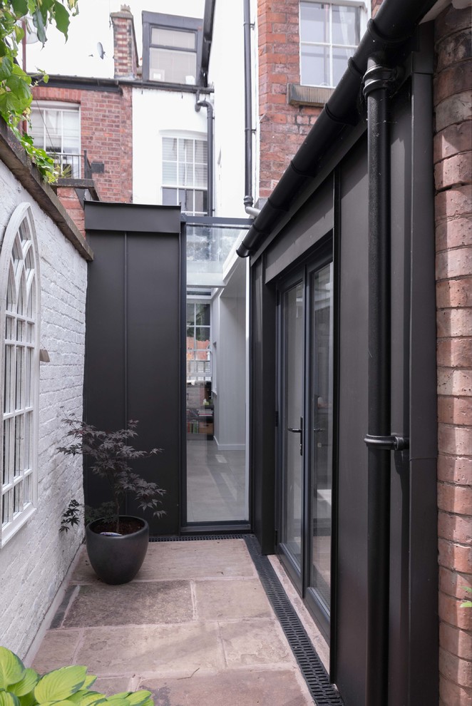This is an example of a scandinavian exterior in Manchester with metal siding.