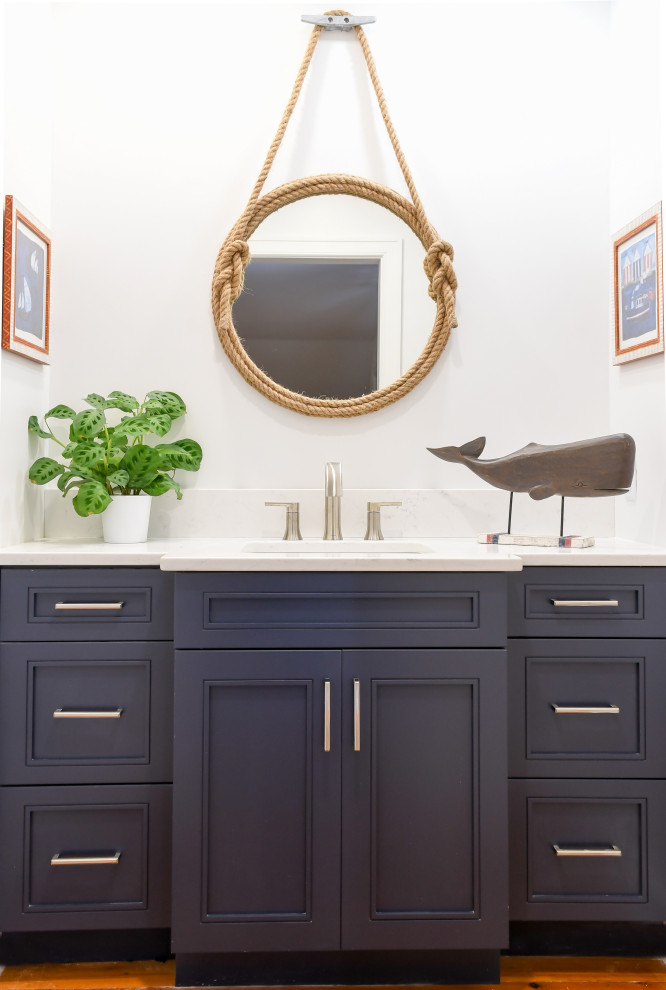 Inspiration for a small beach style kids bathroom in Atlanta with flat-panel cabinets, blue cabinets, white walls, an undermount sink, solid surface benchtops, brown floor, white benchtops, a single vanity and a built-in vanity.