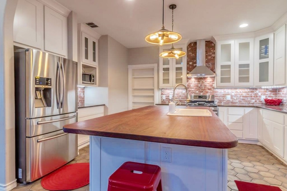 Inspiration for a large transitional u-shaped terra-cotta tile and beige floor enclosed kitchen remodel in Austin with a drop-in sink, shaker cabinets, white cabinets, granite countertops, red backsplash, brick backsplash, stainless steel appliances, an island and gray countertops