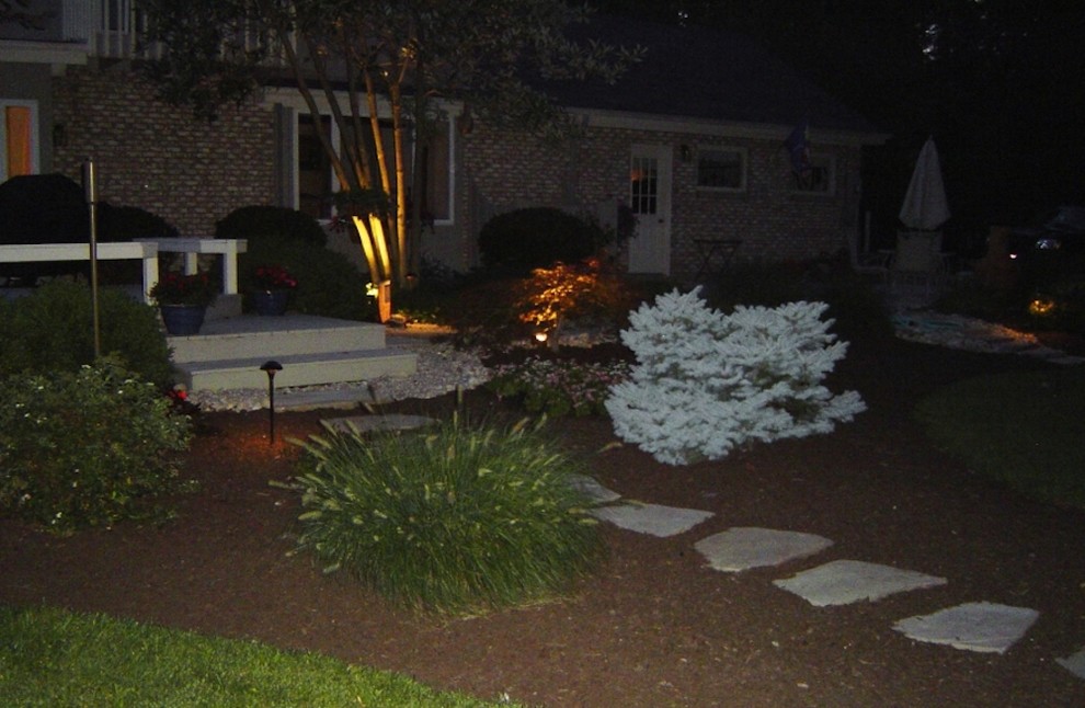 This is an example of a mid-sized transitional front yard stone landscaping.