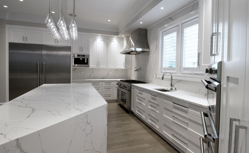 Eat-in kitchen - large transitional u-shaped light wood floor and gray floor eat-in kitchen idea in Charlotte with shaker cabinets, white cabinets, quartzite countertops, white backsplash, stainless steel appliances, two islands and white countertops