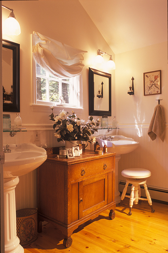Photo of a traditional bathroom in New York with a pedestal sink and distressed cabinets.