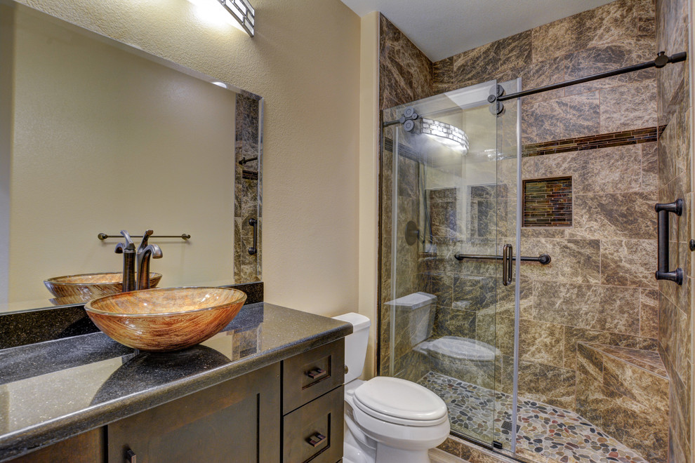 Photo of a small country 3/4 bathroom in Las Vegas with dark wood cabinets, an alcove shower, brown tile, beige walls, ceramic floors, a vessel sink and granite benchtops.