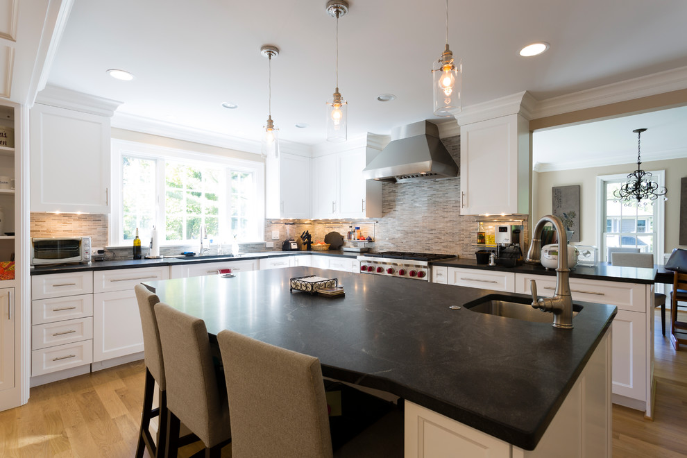 Enclosed kitchen - large transitional l-shaped light wood floor and brown floor enclosed kitchen idea in DC Metro with an undermount sink, recessed-panel cabinets, white cabinets, soapstone countertops, multicolored backsplash, matchstick tile backsplash, stainless steel appliances and an island
