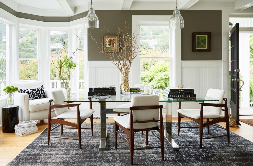 Photo of a transitional dining room in San Francisco with light hardwood floors, green walls and brown floor.