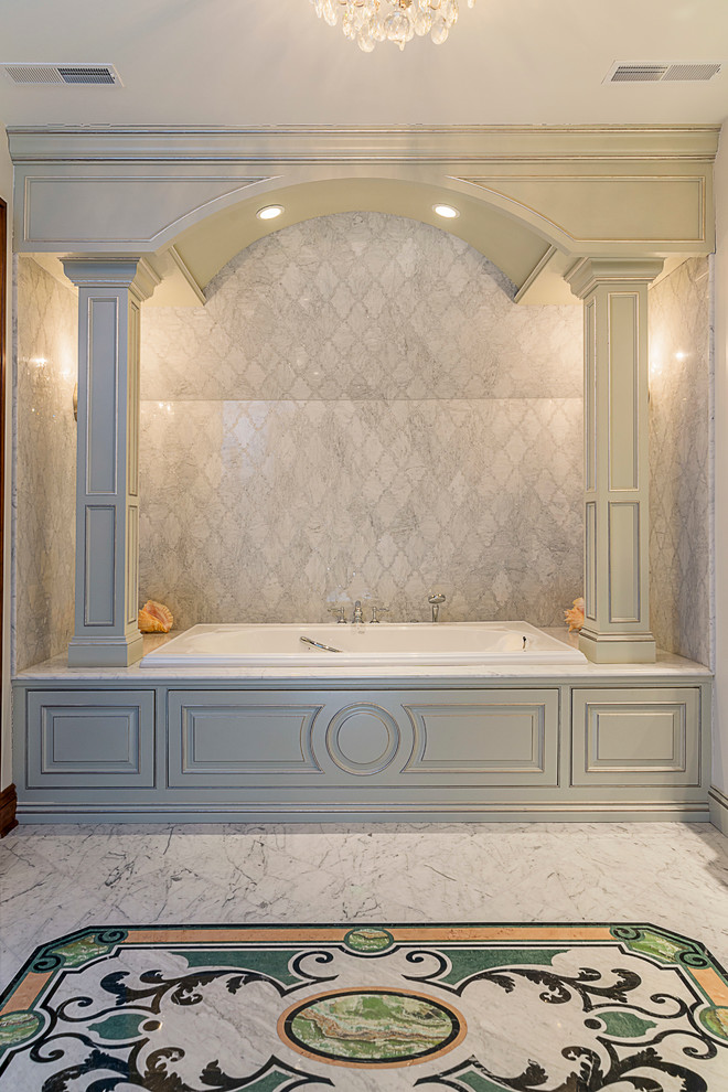 Large traditional master bathroom in Chicago with an undermount sink, beaded inset cabinets, green cabinets, marble benchtops, a drop-in tub, an alcove shower, a two-piece toilet, gray tile, stone tile, beige walls and marble floors.