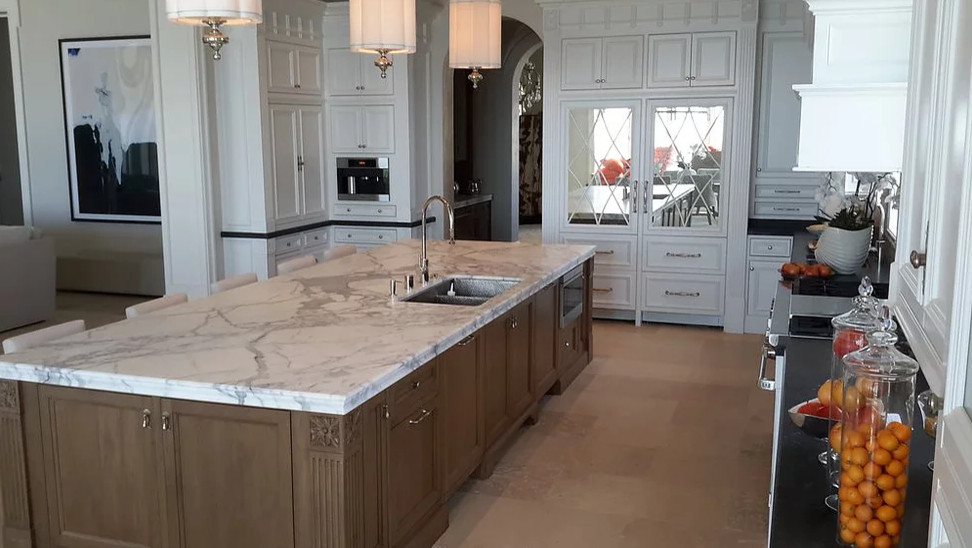 Example of a huge kitchen design in Orange County with an island