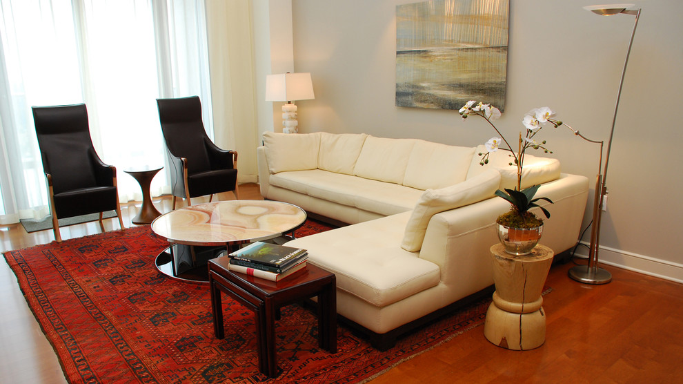 Large trendy formal and loft-style medium tone wood floor living room photo in Atlanta with gray walls, a standard fireplace, a tile fireplace and a wall-mounted tv