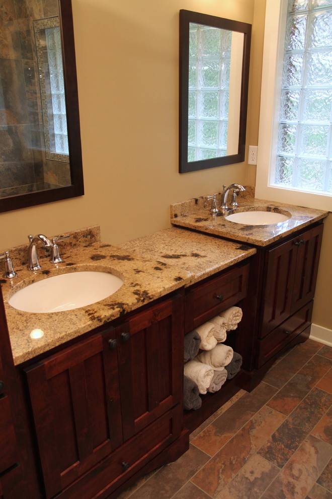 Inspiration for a small country master bathroom in Minneapolis with an undermount sink, flat-panel cabinets, medium wood cabinets, granite benchtops, porcelain floors, a corner shower, porcelain tile and beige walls.