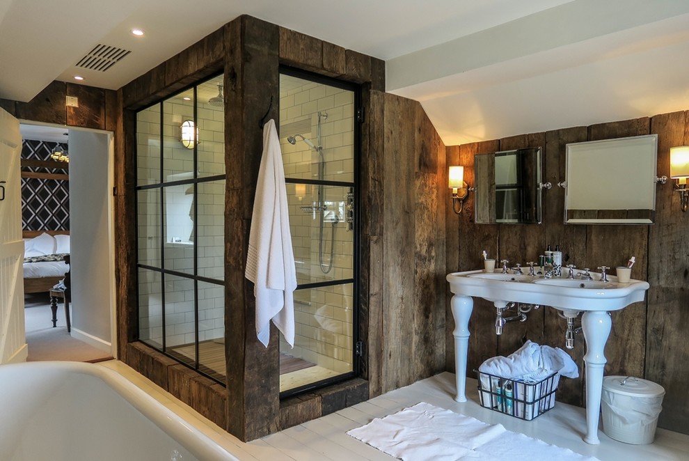 Design ideas for a large traditional master bathroom in London with a claw-foot tub, a two-piece toilet, white tile, ceramic tile, white walls, painted wood floors, a console sink, white floor and a hinged shower door.