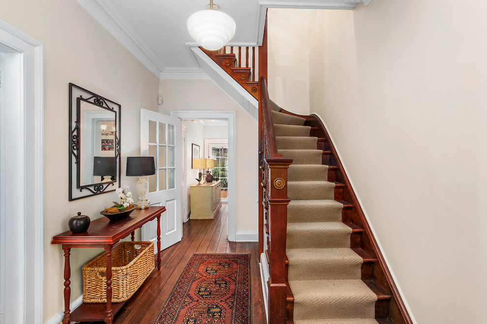 Traditional wood l-shaped staircase in Sydney with wood risers.