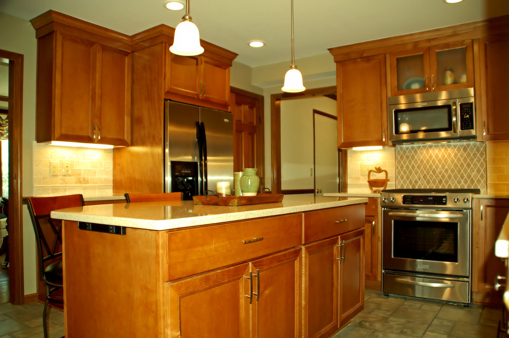Mid-sized transitional l-shaped ceramic tile eat-in kitchen photo in Columbus with an undermount sink, flat-panel cabinets, medium tone wood cabinets, quartz countertops, beige backsplash, stone tile backsplash, stainless steel appliances and an island