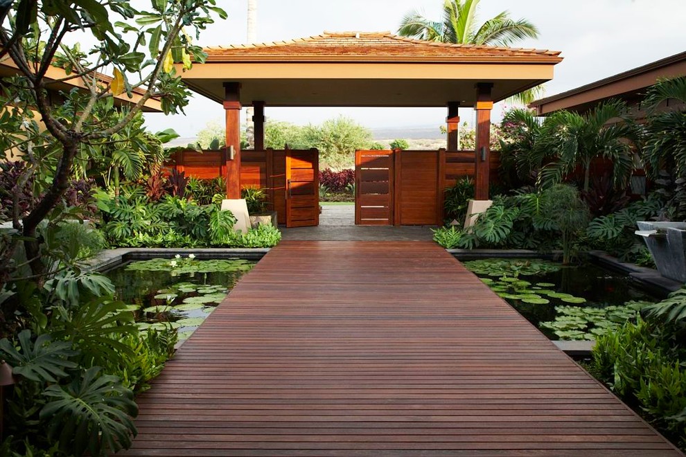 Inspiration for a tropical garden in Hawaii with a water feature and decking.