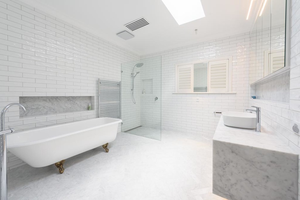 Design ideas for a large traditional bathroom in Melbourne with flat-panel cabinets, white cabinets, a claw-foot tub, a one-piece toilet, white tile, ceramic tile, white walls, marble floors, a vessel sink, marble benchtops and multi-coloured floor.