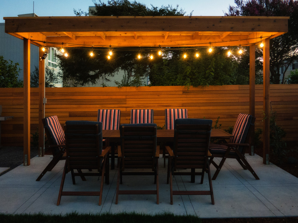 Photo of a small modern backyard patio in San Francisco with a fire feature and decking.