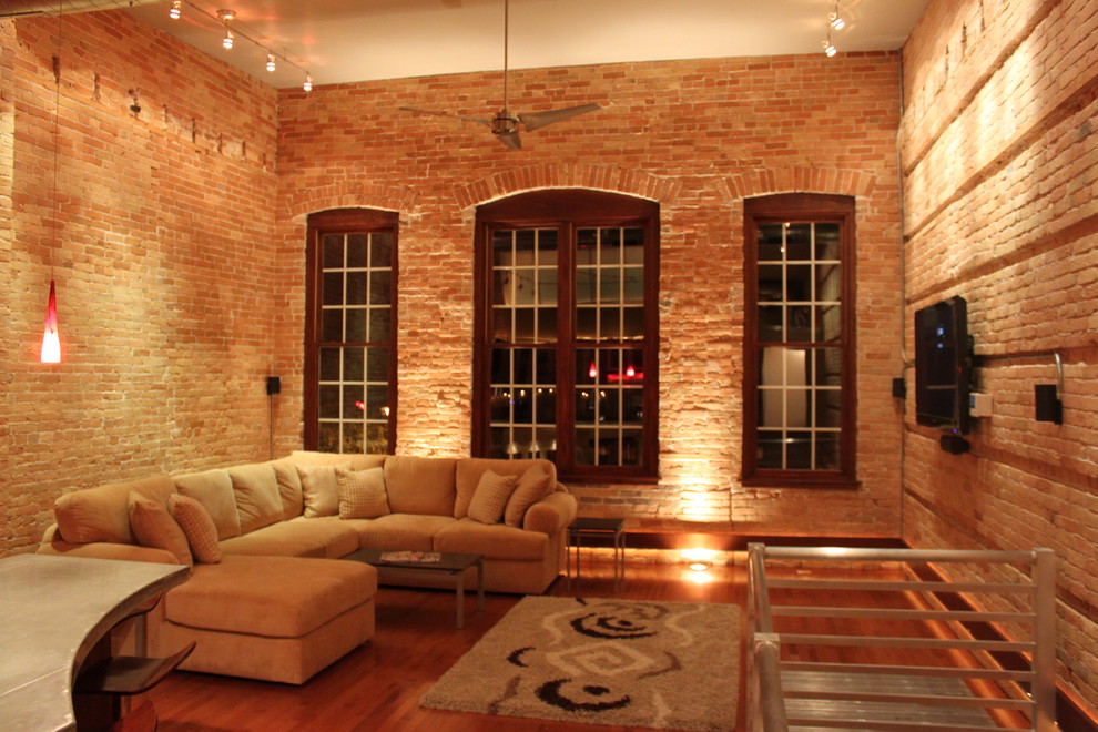 Photo of a small modern loft-style living room in Other with medium hardwood floors.