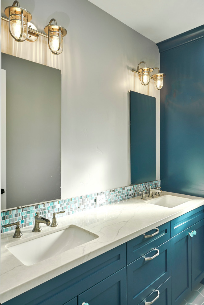 This is an example of a large contemporary kids bathroom in San Francisco with shaker cabinets, blue cabinets, an alcove tub, a shower/bathtub combo, a two-piece toilet, blue tile, porcelain tile, white walls, ceramic floors, an undermount sink, engineered quartz benchtops, blue floor, a sliding shower screen, grey benchtops, a niche, a double vanity and a built-in vanity.