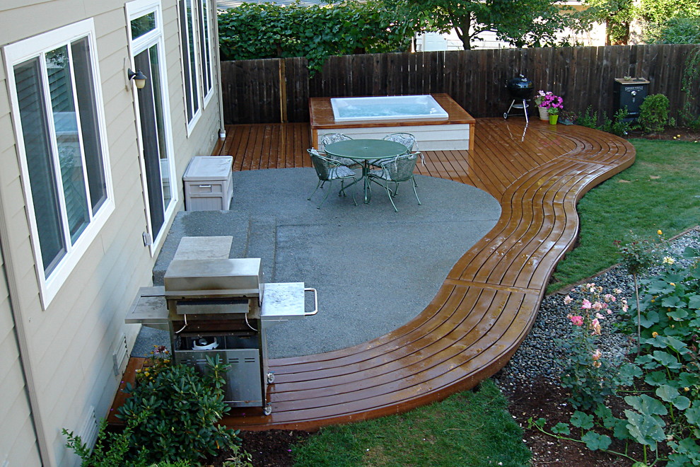 Transitional backyard patio fountain photo in Seattle with no cover and decking