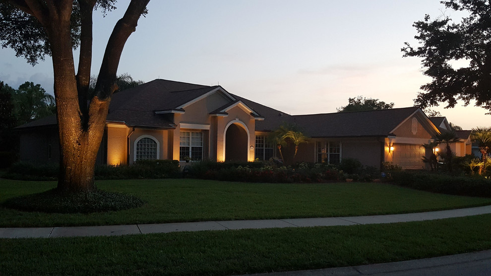 Mid-sized contemporary two-storey beige exterior in Orlando with mixed siding and a clipped gable roof.