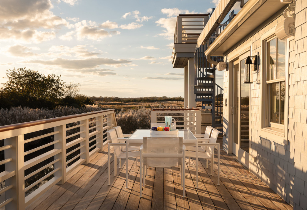 Deck - coastal backyard second story wood railing deck idea in Philadelphia with an awning