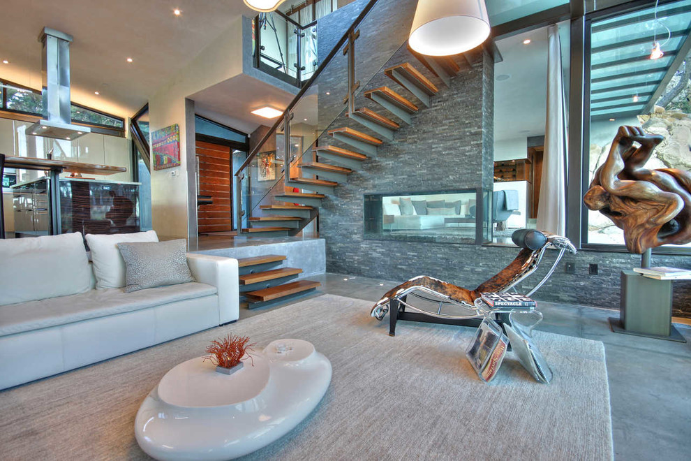Photo of a modern living room in Cincinnati with concrete floors, grey walls and grey floor.