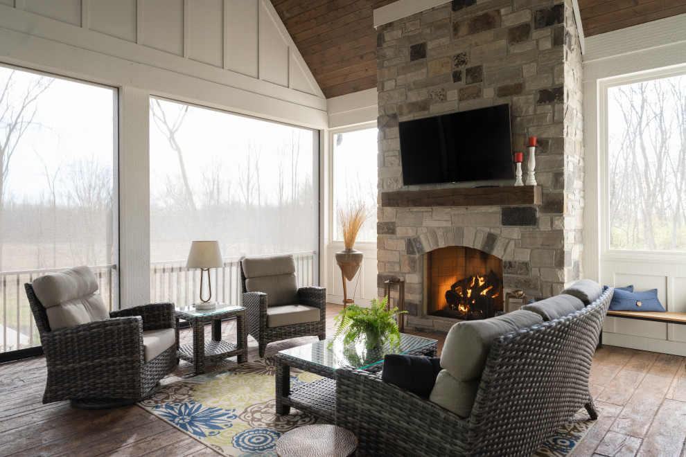 Photo of a mid-sized country family room in Indianapolis with multi-coloured walls, carpet, a standard fireplace and a metal fireplace surround.