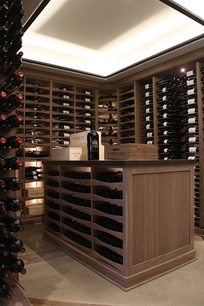 Example of a large transitional wine cellar design with display racks