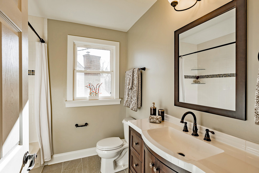 Inspiration for a mid-sized transitional master white tile and ceramic tile ceramic tile, gray floor and single-sink alcove bathtub remodel in Wilmington with recessed-panel cabinets, dark wood cabinets, a two-piece toilet, gray walls, an integrated sink, solid surface countertops, white countertops and a freestanding vanity