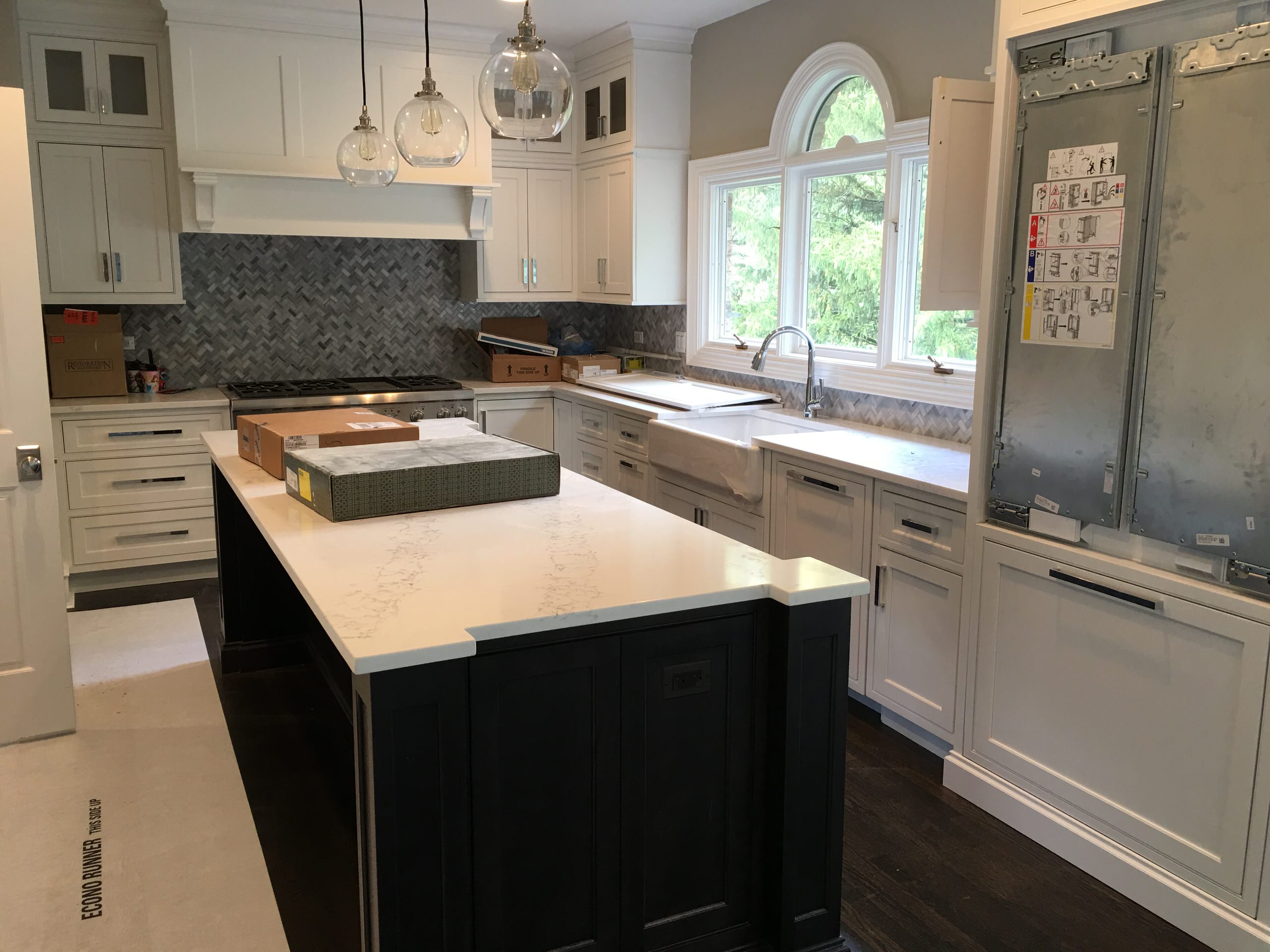 Transitional White Kitchen with Dark Stained island & Quartz Countertops