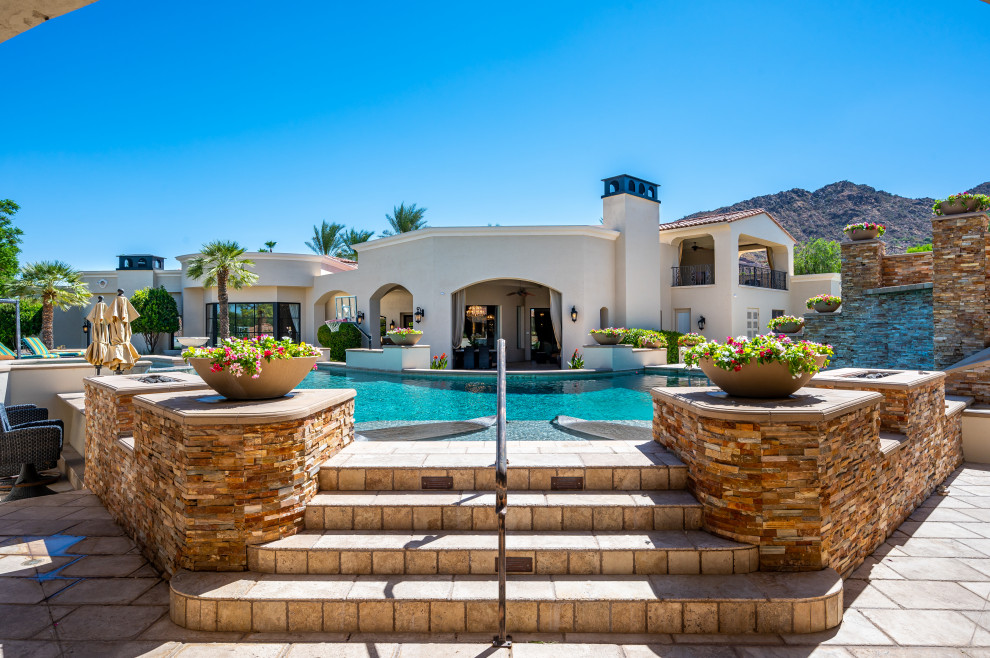 Inspiration for a huge modern backyard concrete paver and custom-shaped lap water slide remodel in Phoenix