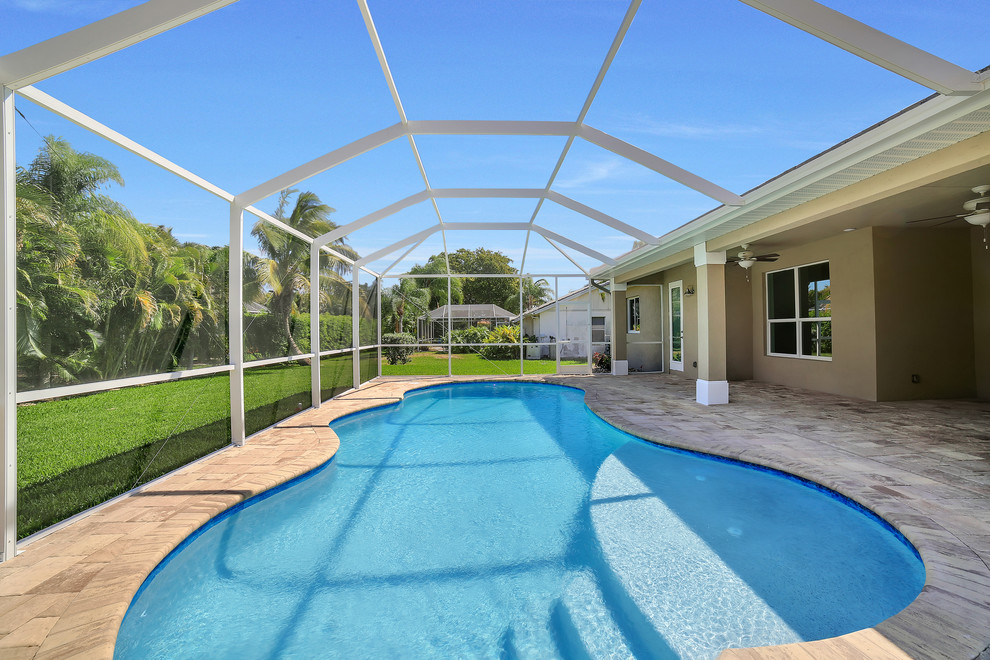 Pool - mid-sized transitional backyard brick and kidney-shaped pool idea