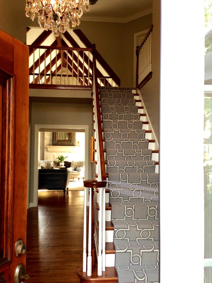 Example of a large transitional medium tone wood floor foyer design in Chicago with gray walls and a dark wood front door