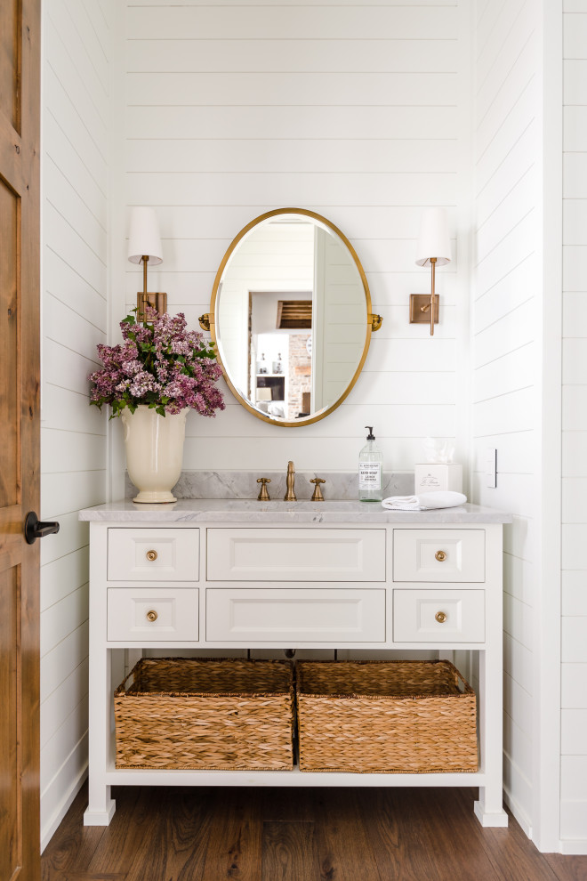 This is an example of a small country powder room in Orlando with raised-panel cabinets, grey cabinets, a drop-in sink, marble benchtops, grey benchtops and a built-in vanity.