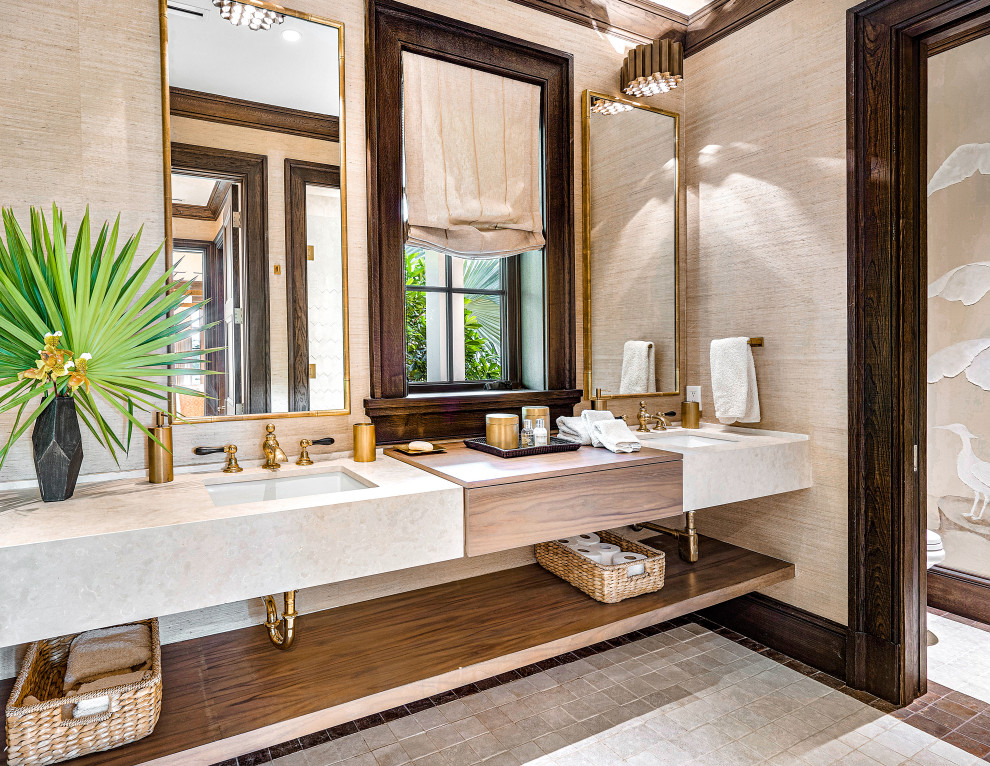 Design ideas for an expansive tropical wet room bathroom in Miami with flat-panel cabinets, dark wood cabinets, a one-piece toilet, white tile, terra-cotta tile, beige walls, terra-cotta floors, an undermount sink, limestone benchtops, beige floor, a hinged shower door, beige benchtops, an enclosed toilet, a double vanity, a floating vanity and wallpaper.