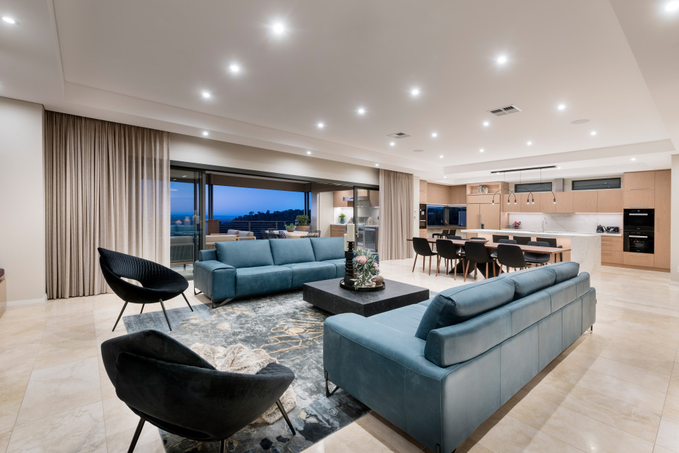 Photo of an expansive contemporary open concept living room in Perth with beige walls, travertine floors, a standard fireplace and beige floor.