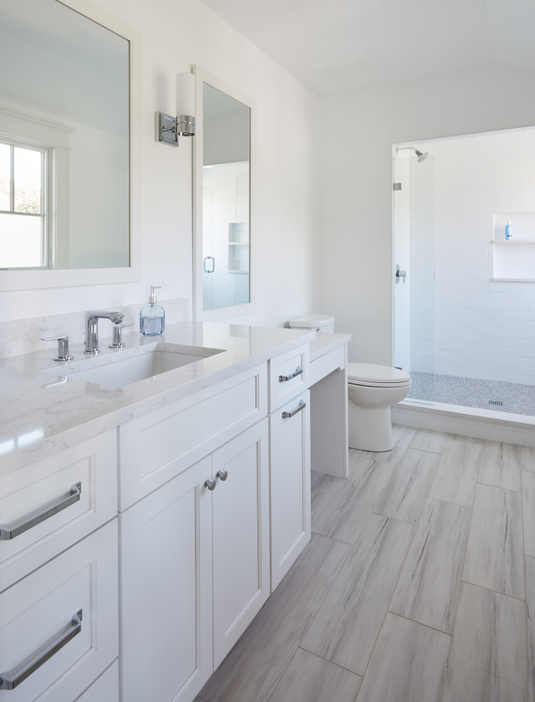 Bathroom - mid-sized kids' white tile and ceramic tile porcelain tile, gray floor and single-sink bathroom idea in Chicago with recessed-panel cabinets, white cabinets, a two-piece toilet, white walls, an undermount sink, quartz countertops, a hinged shower door, white countertops and a built-in vanity