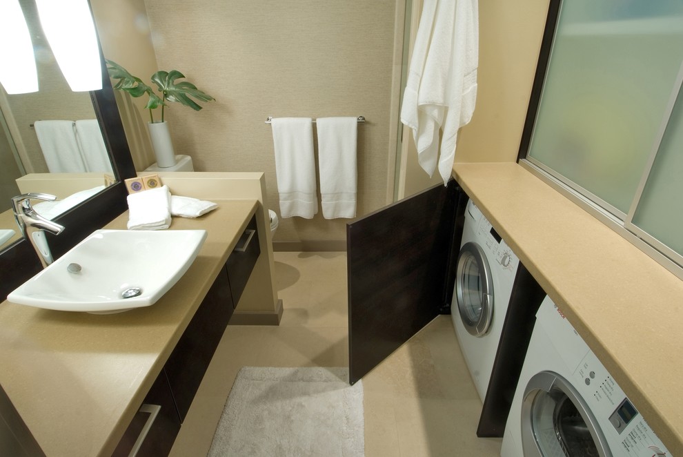 This is an example of a contemporary bathroom in Hawaii with solid surface benchtops, a vessel sink and a laundry.