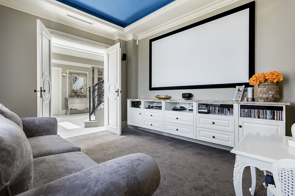 This is an example of a traditional enclosed home theatre in Sydney with grey walls, carpet, a projector screen and grey floor.